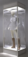 A Single Mannequin Showcase displays a white mannequin dressed in a long-sleeve shirt and knee-high brown boots, standing inside its tall, lockable cabinet with interior lighting.