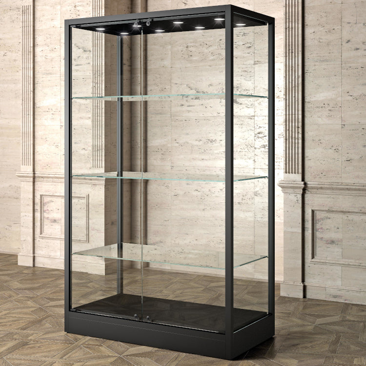 The Bravura MU120FC Display Showcase, featuring a black metal frame, tempered glass panels, and shelves, stands empty against a beige marble wall with decorative paneling and a patterned wooden floor.